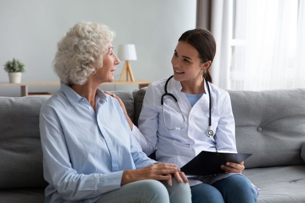 Caring young woman nurse helping supporting old adult grandmother patient in 690 Van Buren St, Eugene, OR| Refine Medical Center